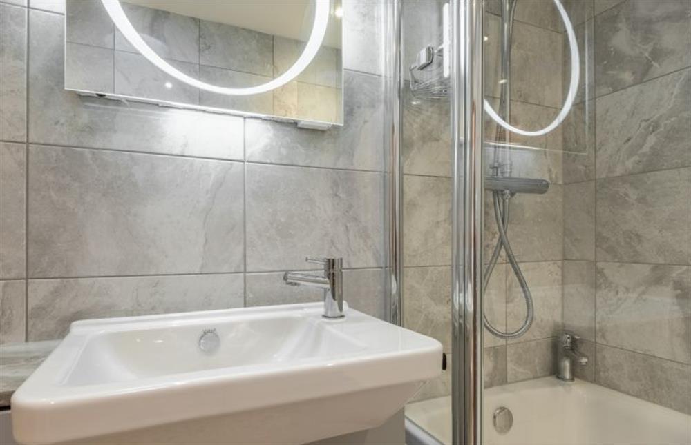 The bathroom has bath with shower over at Hollyhocks, Docking near Kings Lynn
