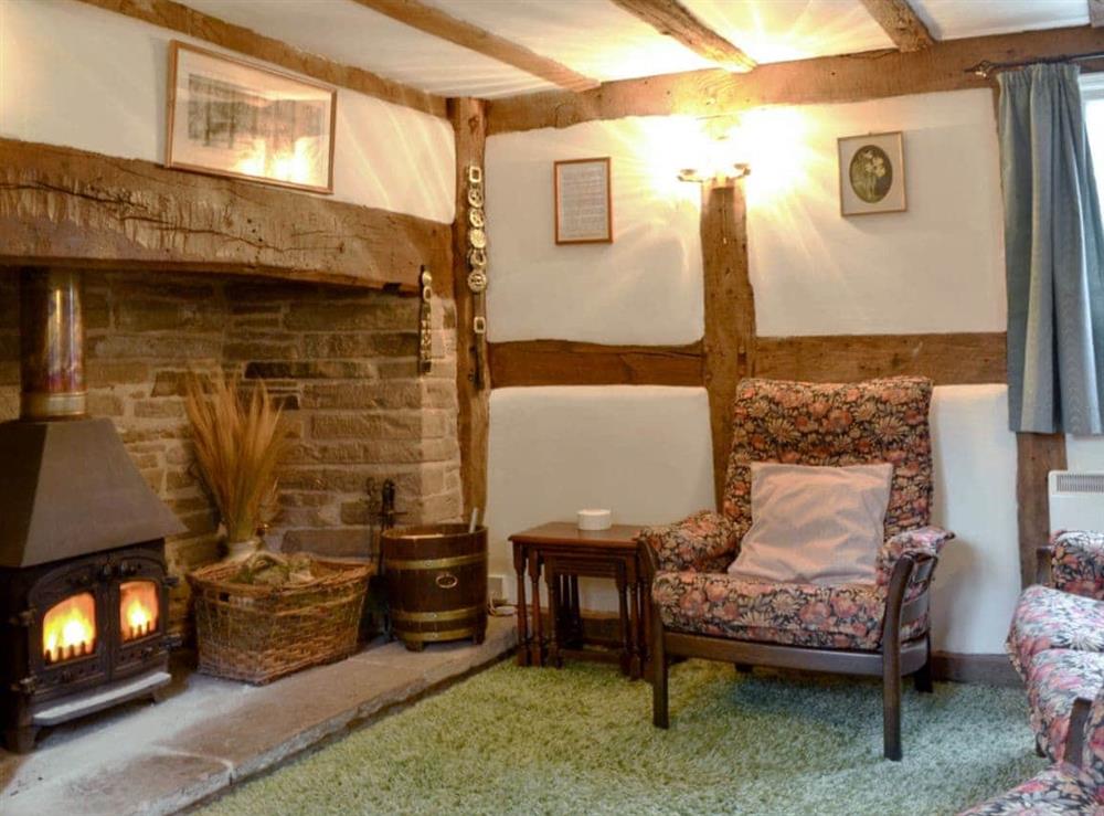 Impressive living room/dining room with beams and cosy woodburner (photo 2) at Hollywall Croft in Stoke Prior, near Leominster, Herefordshire