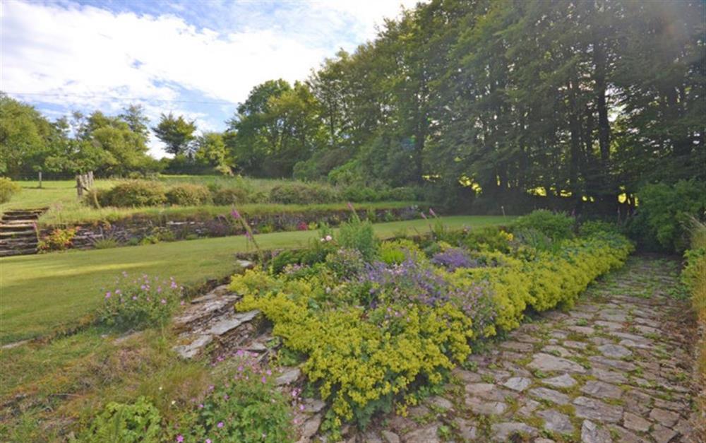 Lovely terraced gardens with mature shrubs and flowers. at Holmbush in Withypool