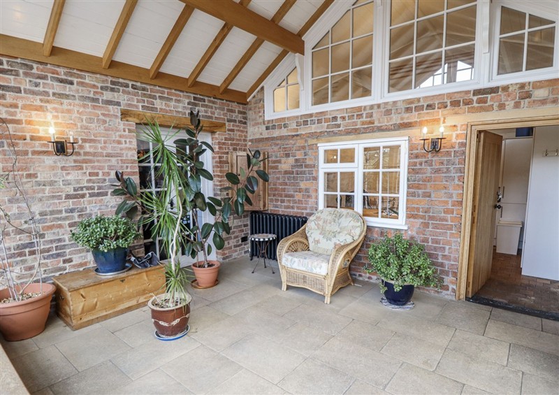 Enjoy a glass of wine on the patio at Holme Farm, Ruskington