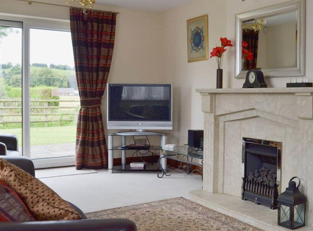 Bright and airy living room with feature fireplace at Holme View in Clifton, near Ashbourne, Derbyshire