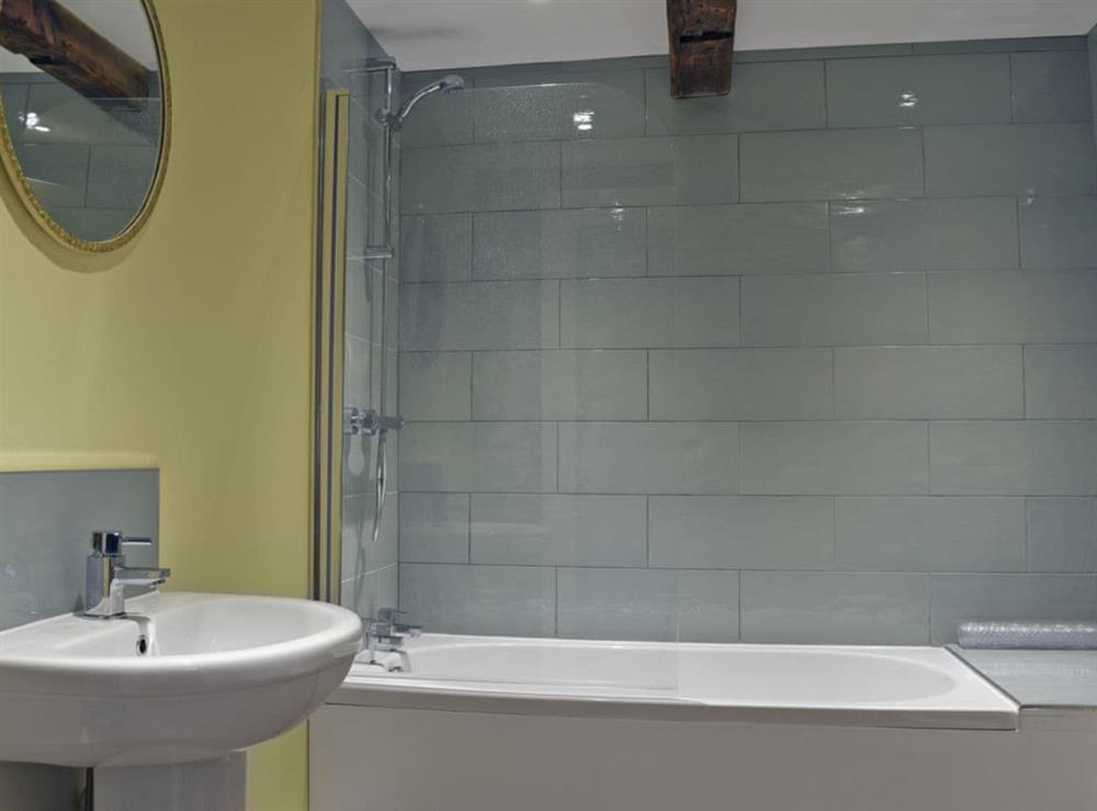 Bathroom with shower over bath at Waxwing Cottage, 