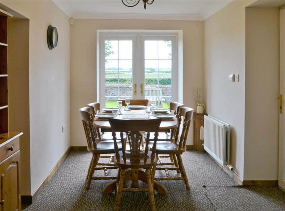Light and airy dining area with French doors to garden at Holmlea in Newtown, near Silloth, Cumbria