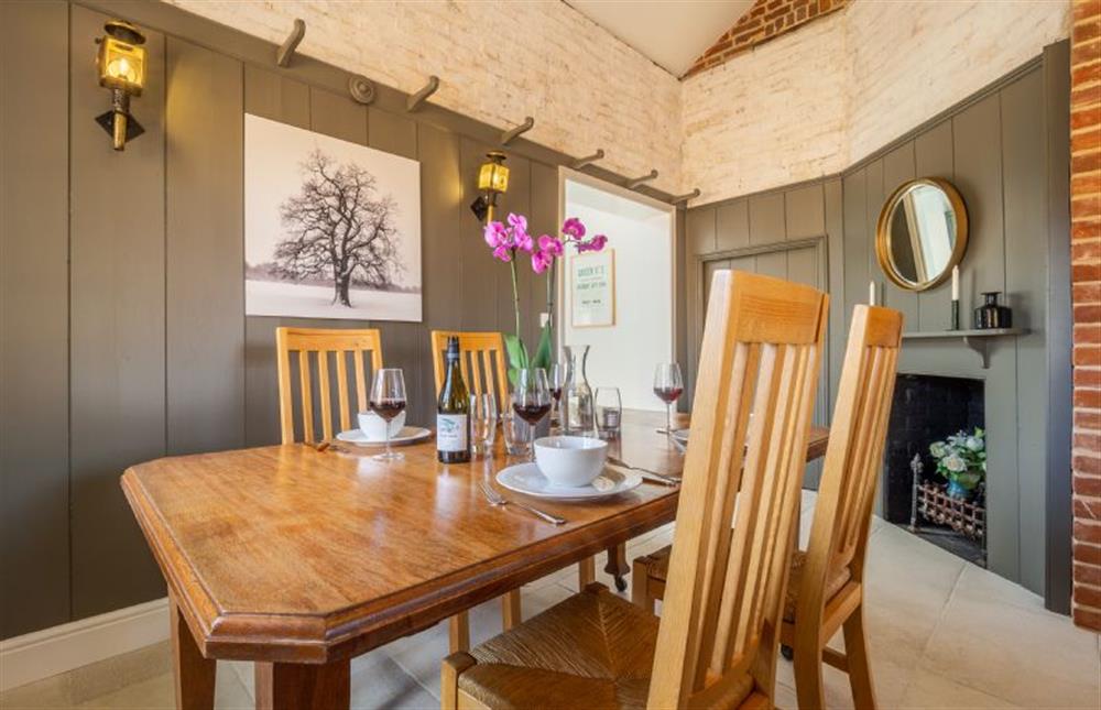Dining area with farmhouse wooden table and chairs at Holt Coach House, Edwardstone