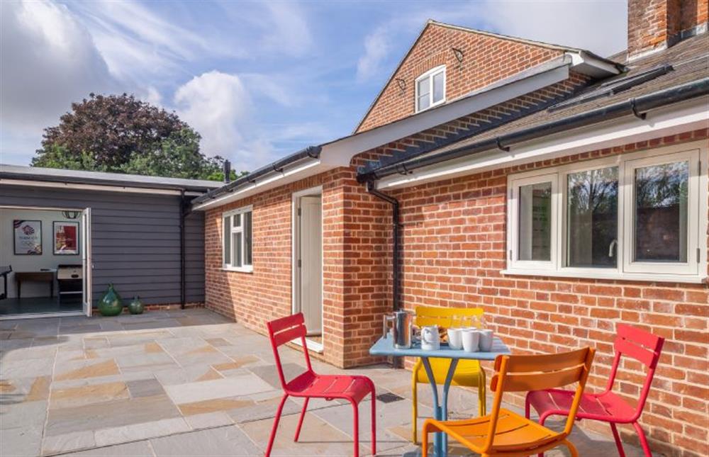 Large enclosed sun terrace with seating for four at Holt Coach House, Edwardstone