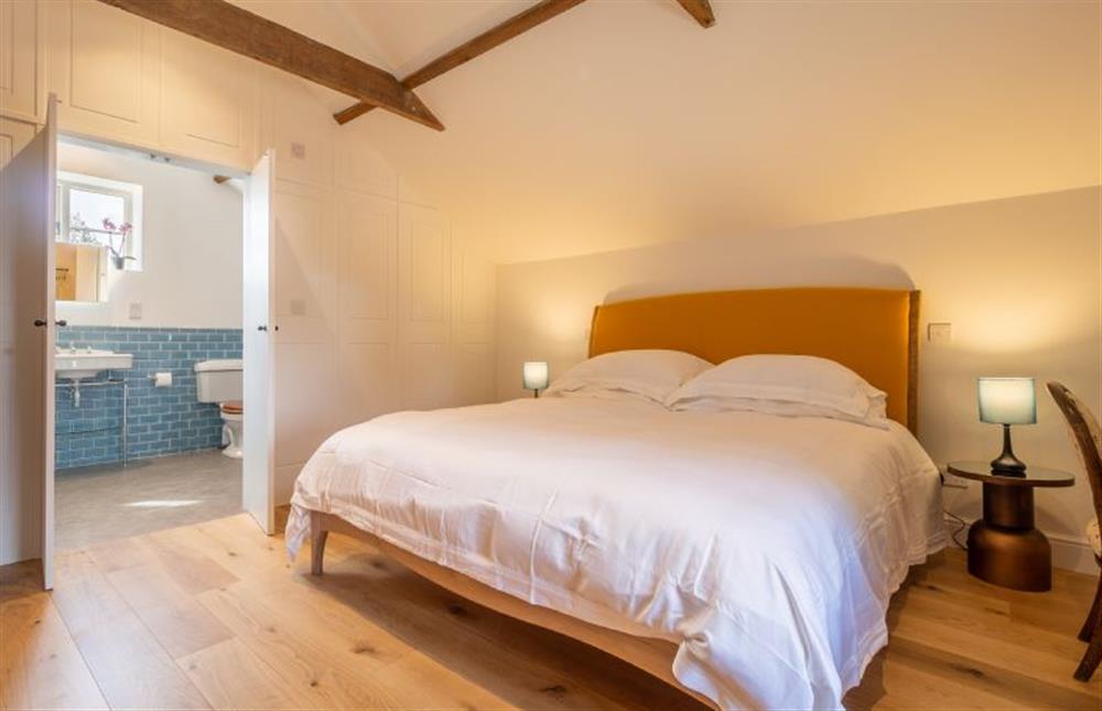 The Hayloft bedroom upstairs, with a super-king size bed and en-suite bathroom at Holt Coach House, Sudbury