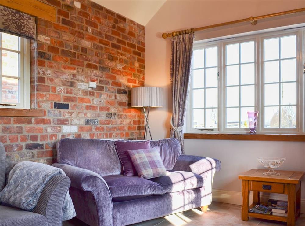 Charming living area with exposed brickwork at Cozy Cottage, 