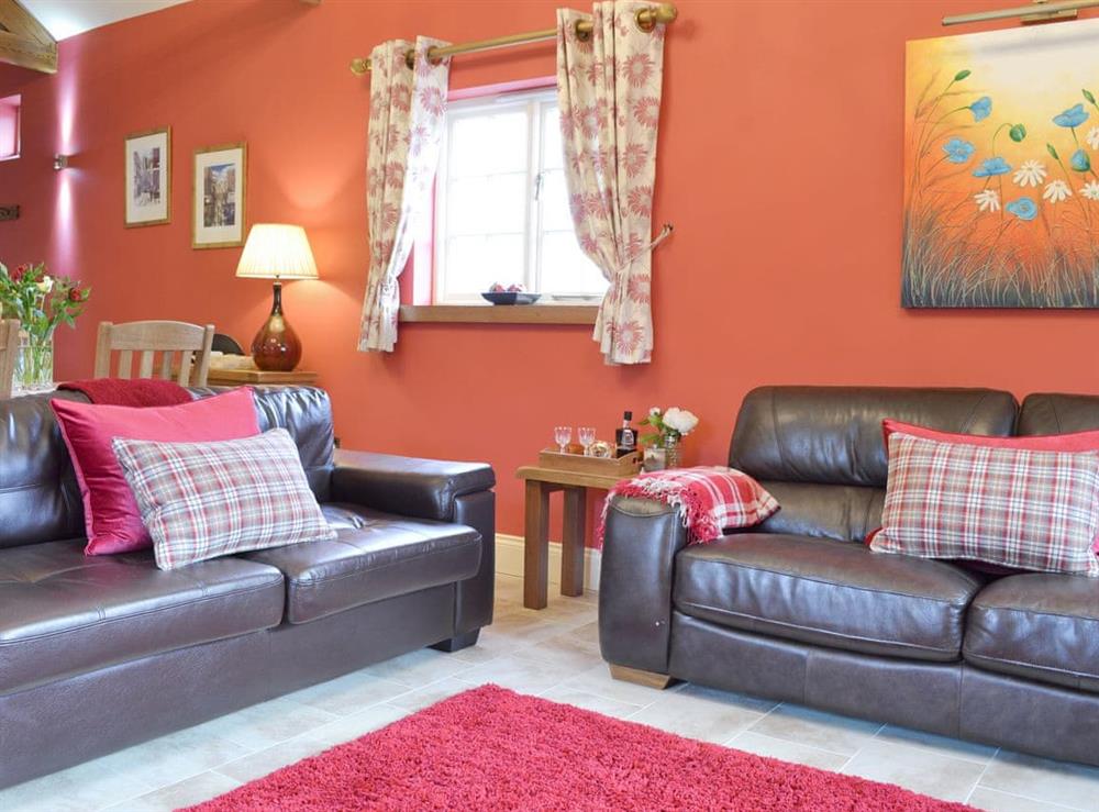 Comfy seating within living area at Owl Cottage, 