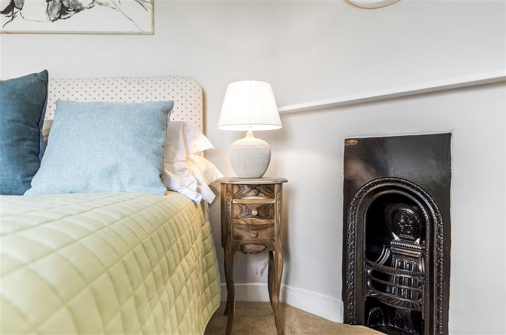 First floor: The double bedroom with characterful ornamental fireplace at Holway Cottage, Cattistock
