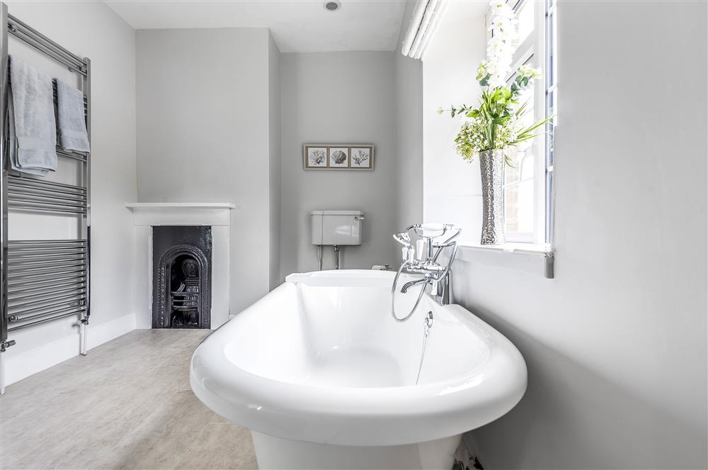 First floor: The spacious en-suite bathroom with roll-top bath at Holway Cottage, Cattistock