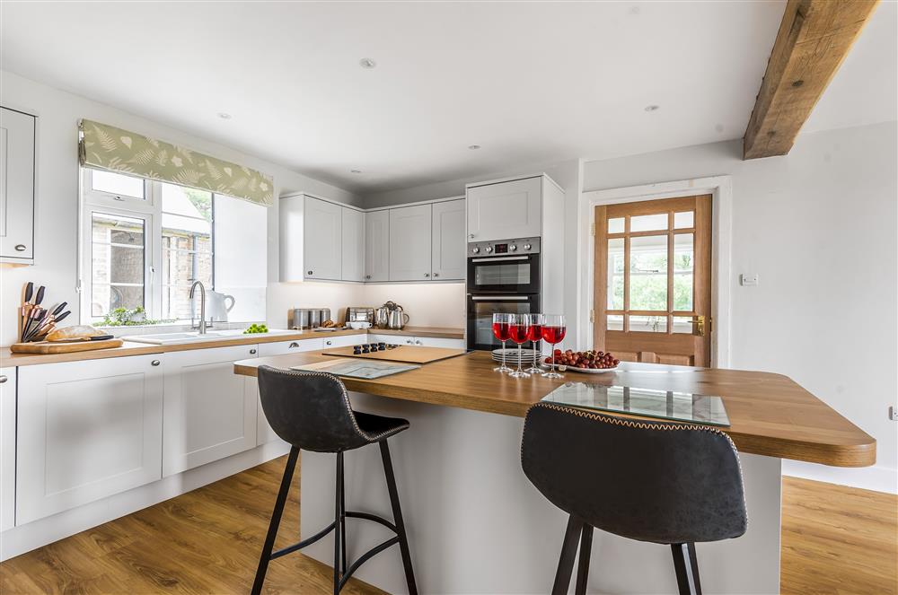 Ground floor: Kitchen with island and bar stools at Holway Cottage, Cattistock