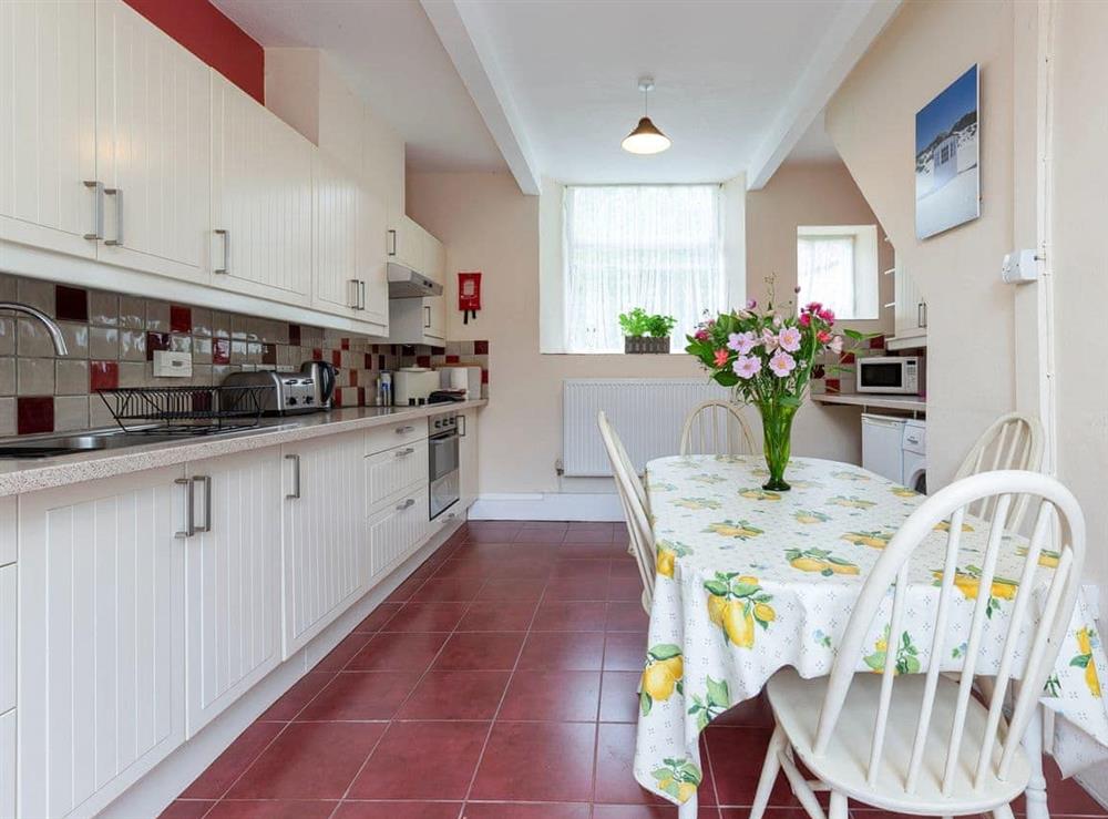 Well equipped kitchen with dining area at The Stables, 
