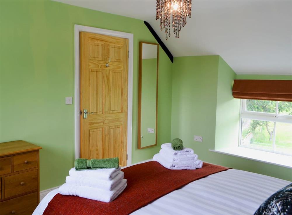 Tranquil bedroom with kingsize bed (photo 2) at Squirrel Cottage, 