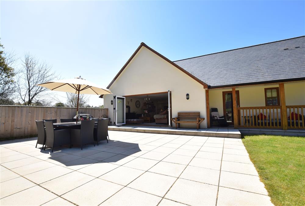 Large patio area with outdoor furniture and gas barbecue  at Holywell House, Wellington
