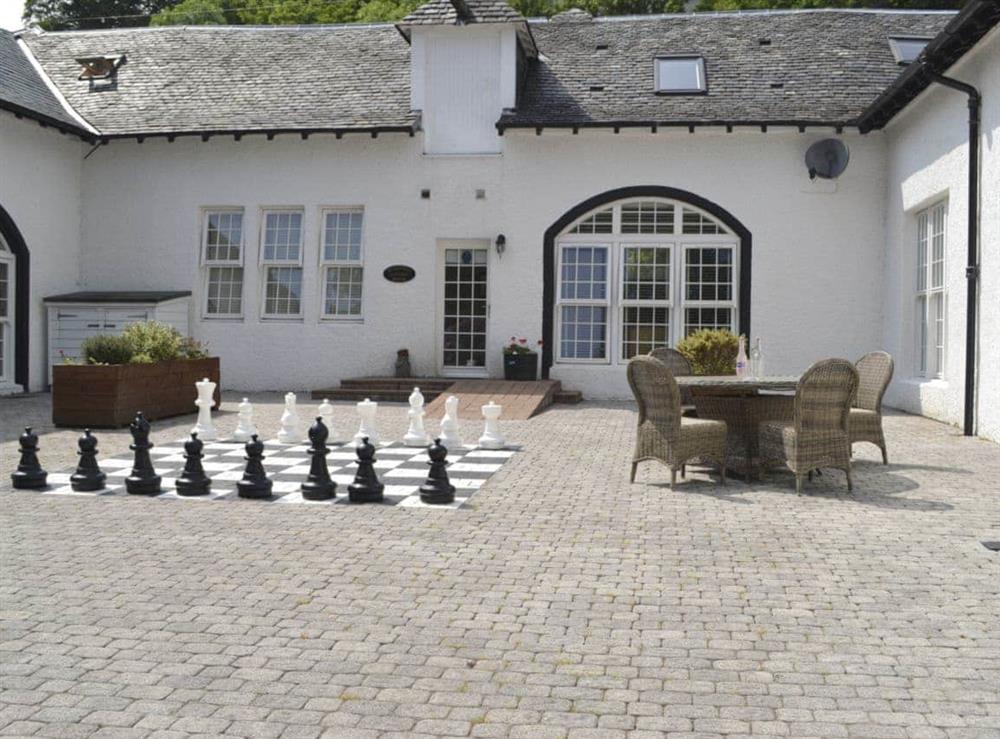 Characterful courtyard with outdoor chess game at Marjorys Cottage, 