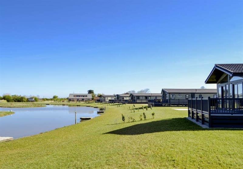 The lodges round the lake at Home Farm Park Lakeside Retreat in Burgh le Marsh, Lincolnshire