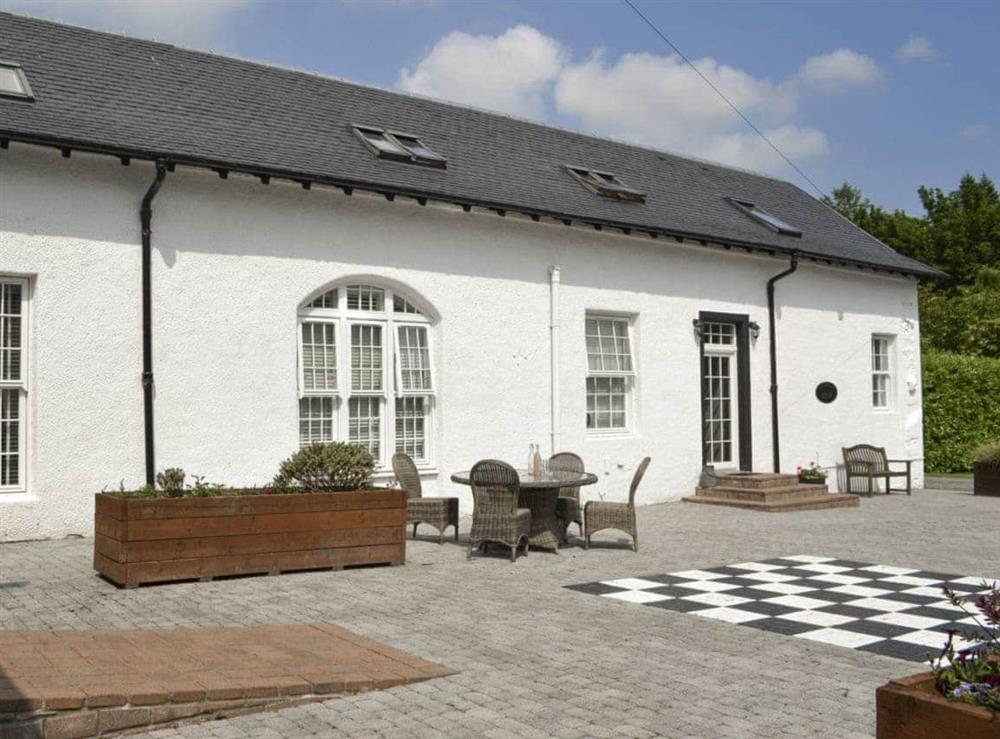 Large patio area with outdoor chess game at The Coach House, 