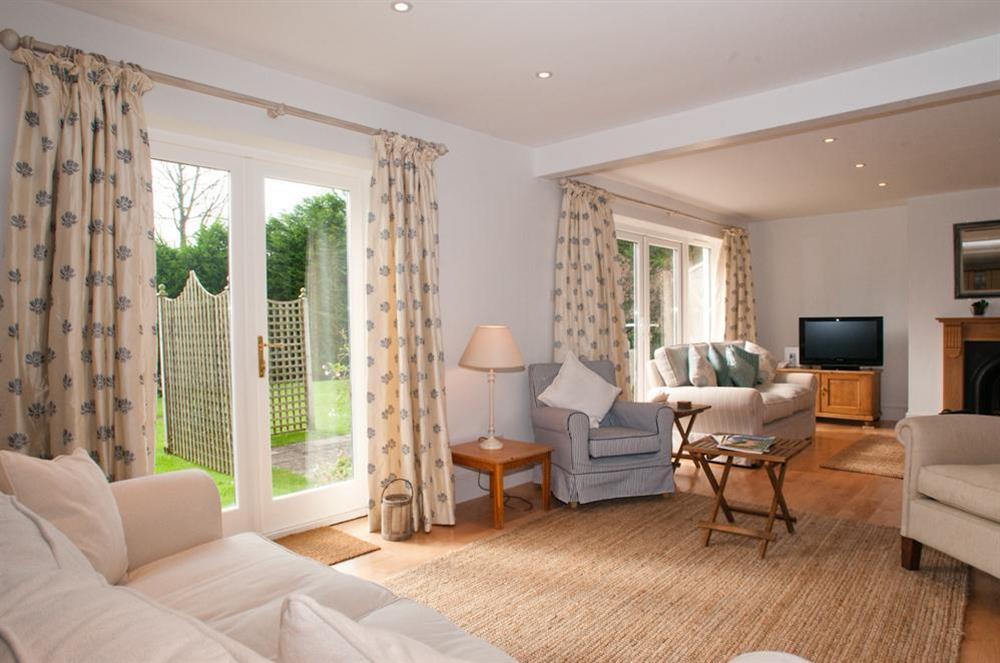 Second seating area with sofa and doors to terrace and garden at Homefield House in Nr Kingsbridge, Devon