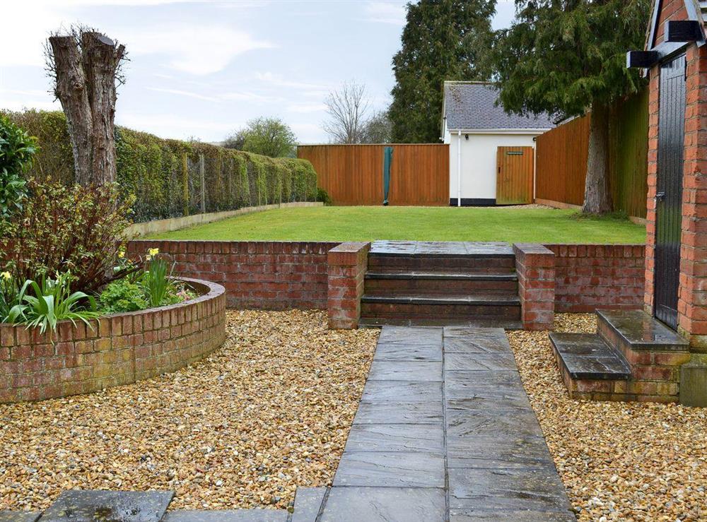 Enclosed garden with patio area at Homestead Cottage in Downton, Wiltshire