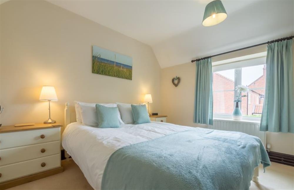 First floor: Master bedroom with king-size bed at Honey Cottage, Sedgeford near Hunstanton