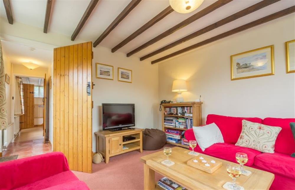 Ground floor: Cheerful sitting room has television and lots of books and games at Honey Cottage, Sedgeford near Hunstanton
