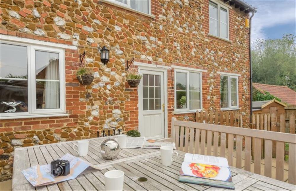 The pretty cottage has local carrstone and chalk walls at Honey Cottage, Sedgeford near Hunstanton