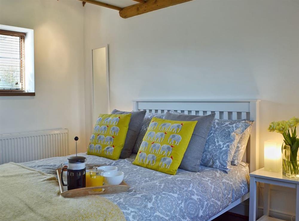 Beautifully presented double bedroom with beams at Honey Meadow Cottage in Sharpthorne, near Haywards Heath, West Sussex