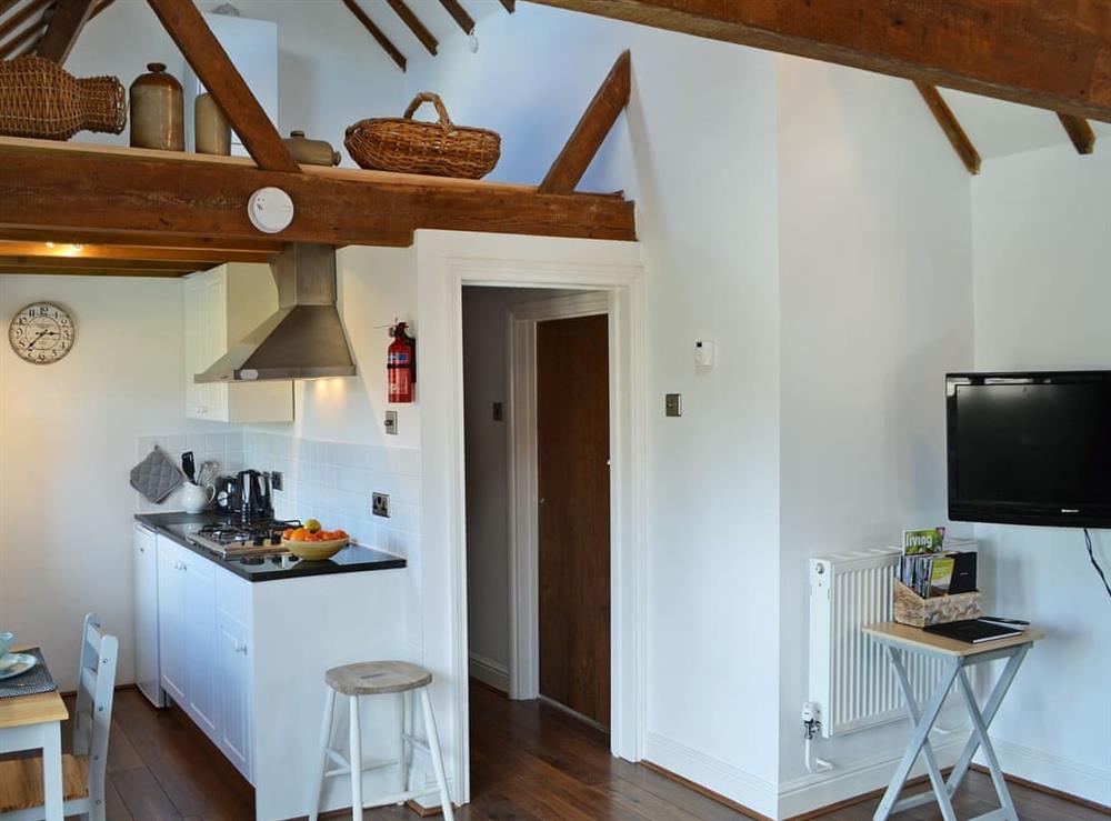 Thoughtfully converted open plan living space with beams at Honey Meadow Cottage in Sharpthorne, near Haywards Heath, West Sussex
