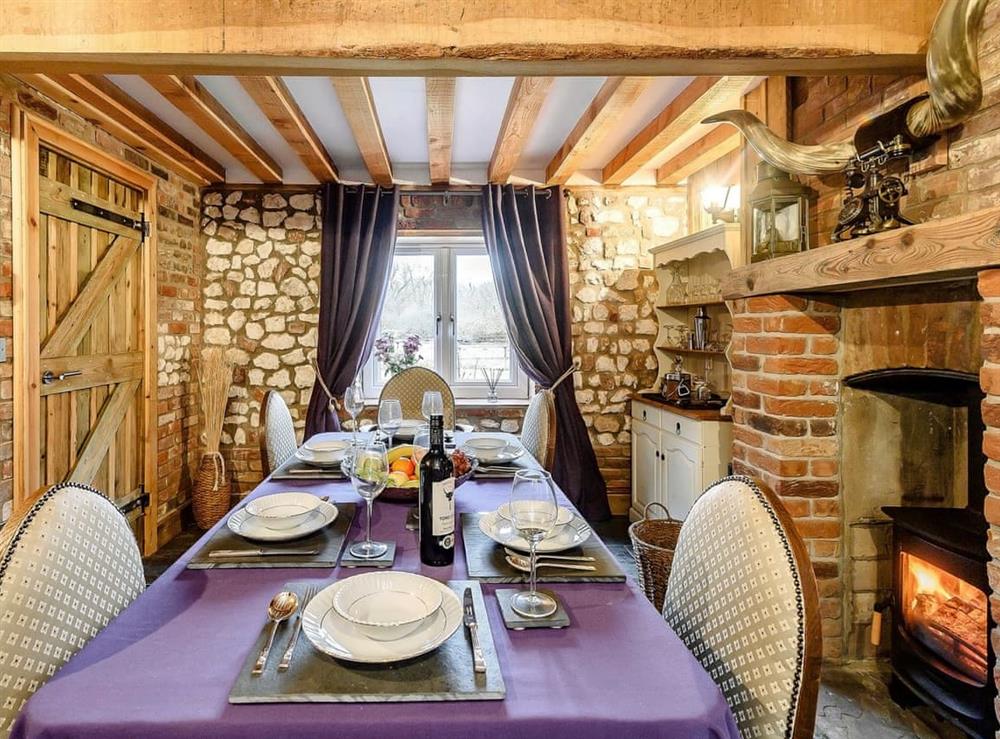 Formal dining room with wood burner at Honey Potts in Foulden, near Swaffham, Norfolk