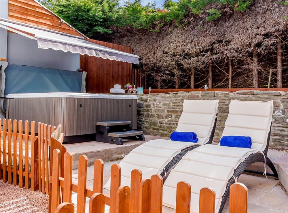 Outdoor area with hot tub at Honeycott in Llangattock, near Crickhowell, Powys
