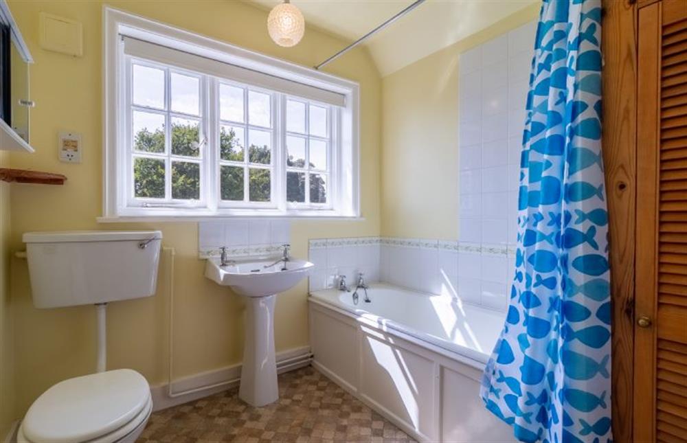 Bathroom with bath with shower over, wash basin and WC at Honeypot Cottage, Falkenham
