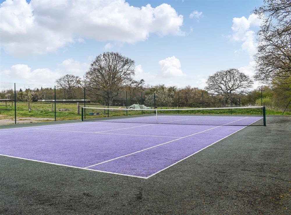 Tennis court at Honeypot Cottage in Piltdown, near Uckfield, Sussex, East Sussex