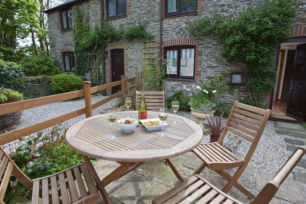 Cosy garden with table chairs and barbeque (photo 2) at Honeysuckle Cottage in Bigbury, Kingsbridge