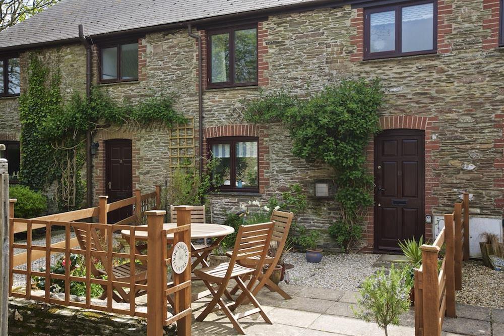 Cosy garden with table chairs and barbeque (photo 4) at Honeysuckle Cottage in Bigbury, Kingsbridge