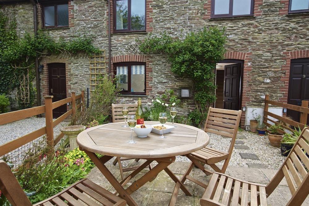 Cosy garden with table chairs and barbeque at Honeysuckle Cottage in Bigbury, Kingsbridge