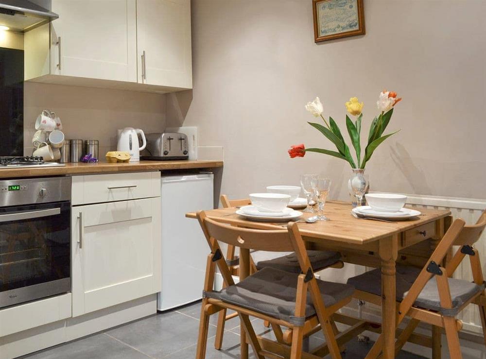 Convenient dining area within kitchen at Honeysuckle Cottage in Brighton, East Sussex