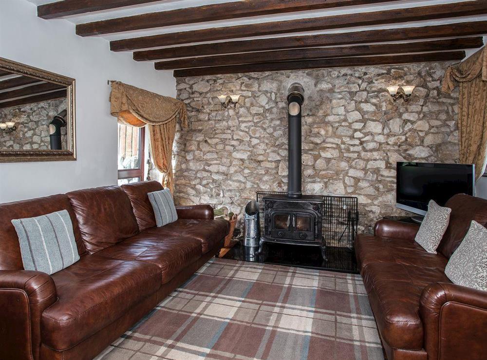 Living room with wood burner at Honeysuckle Cottage in Matlock, Derbyshire