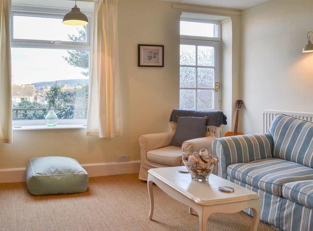 Spacious living room with comfortable furniture at Honeysuckle Cottage in Watchet, Somerset