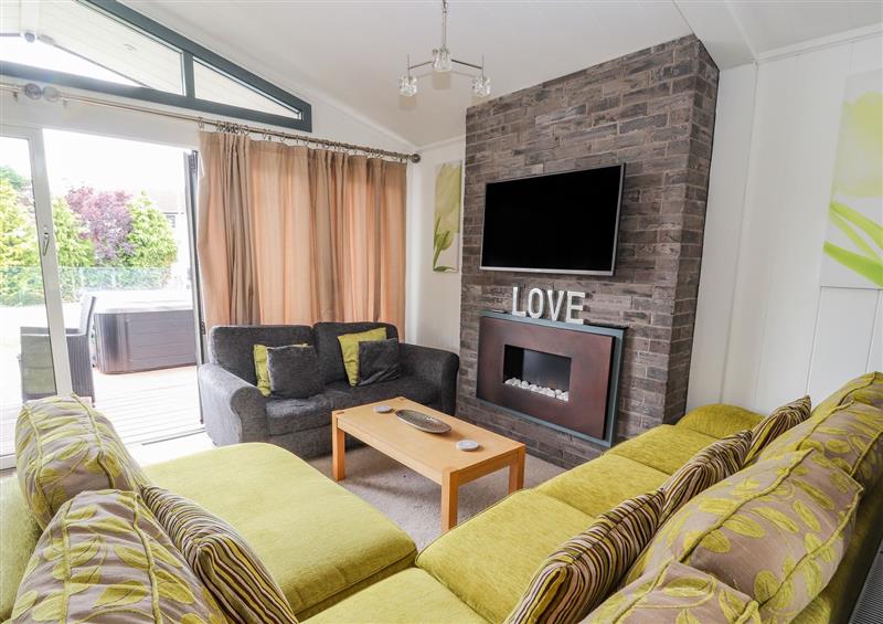 Enjoy the living room at Honeysuckle Lodge, Towyn