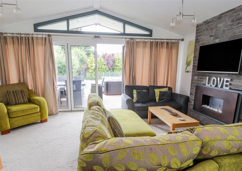 Relax in the living area at Honeysuckle Lodge, Towyn
