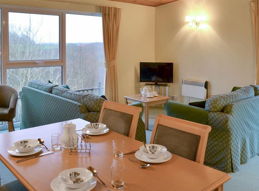 Comfortable living/ dining room at Honeysuckle Lodge in Woolfardisworthy, near Hartland, Devon