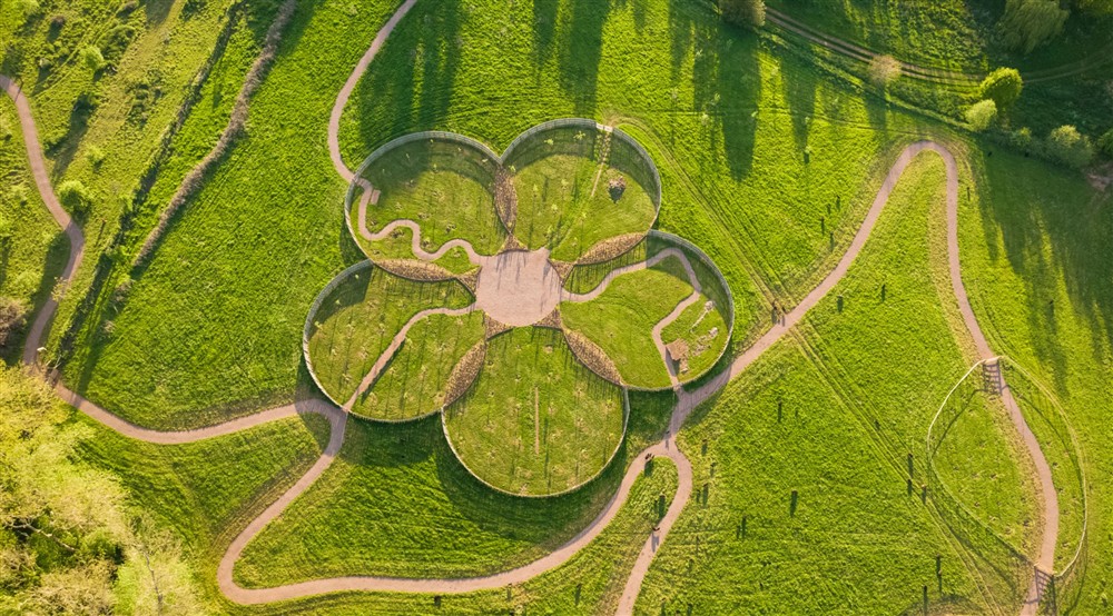 An aerial view of the apple core orchard, with its 5 circular areas that over lap in the centre. The path ways wind through and around the circles, leading out into the rest of the reimagined orchards. at Hop Kiln Cart Barn in Bromyard, Herefordshire