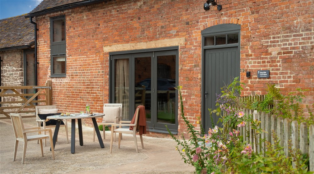 The outdoor seating area at Hop Kiln Cart Barn in Bromyard, Herefordshire
