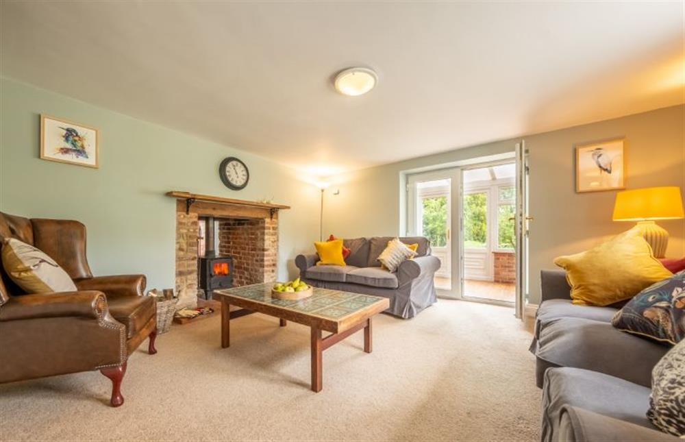 A welcoming, relaxing sitting room with wood burning stove