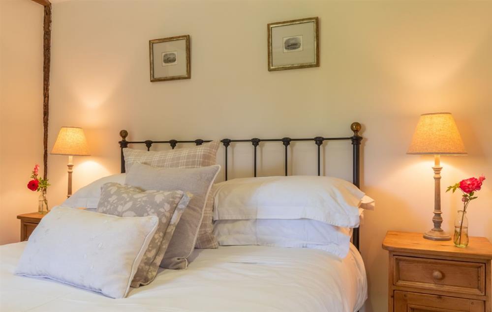 Charming double bedroom with beautiful cast iron bed and plenty of comfortable pillows (photo 2) at Hope Cottage, Henfield