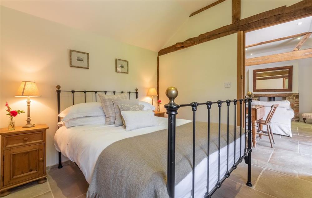 Charming double bedroom with beautiful cast iron bed and plenty of comfortable pillows at Hope Cottage, Henfield