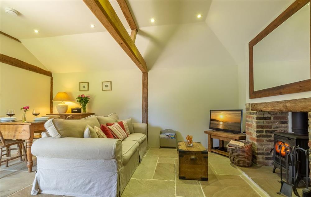 Open plan living area with wood burner and original oak beams (photo 2) at Hope Cottage, Henfield