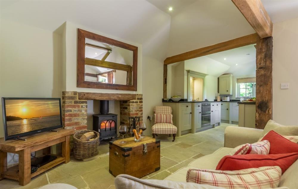 Open plan living area with wood burner and original oak beams (photo 4) at Hope Cottage, Henfield