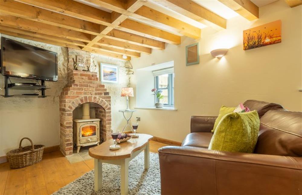 Ground floor: The cosy Sitting room has wood burning stove and exposed beams at Hope Cottage, Holme-next-the-Sea near Hunstanton