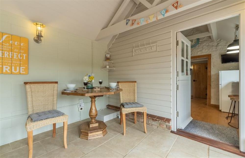 Ground floor: Unusual hexagonal dining table in the Sun room at Hope Cottage, Holme-next-the-Sea near Hunstanton